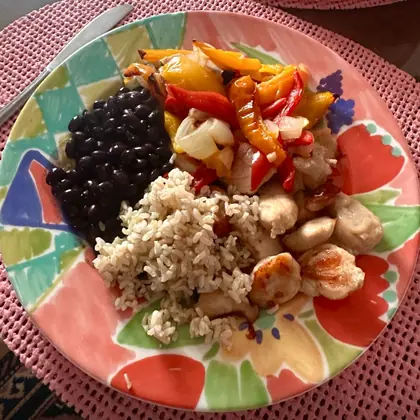 Plate with chicken breast, brown rice, black beans, and bell peppers